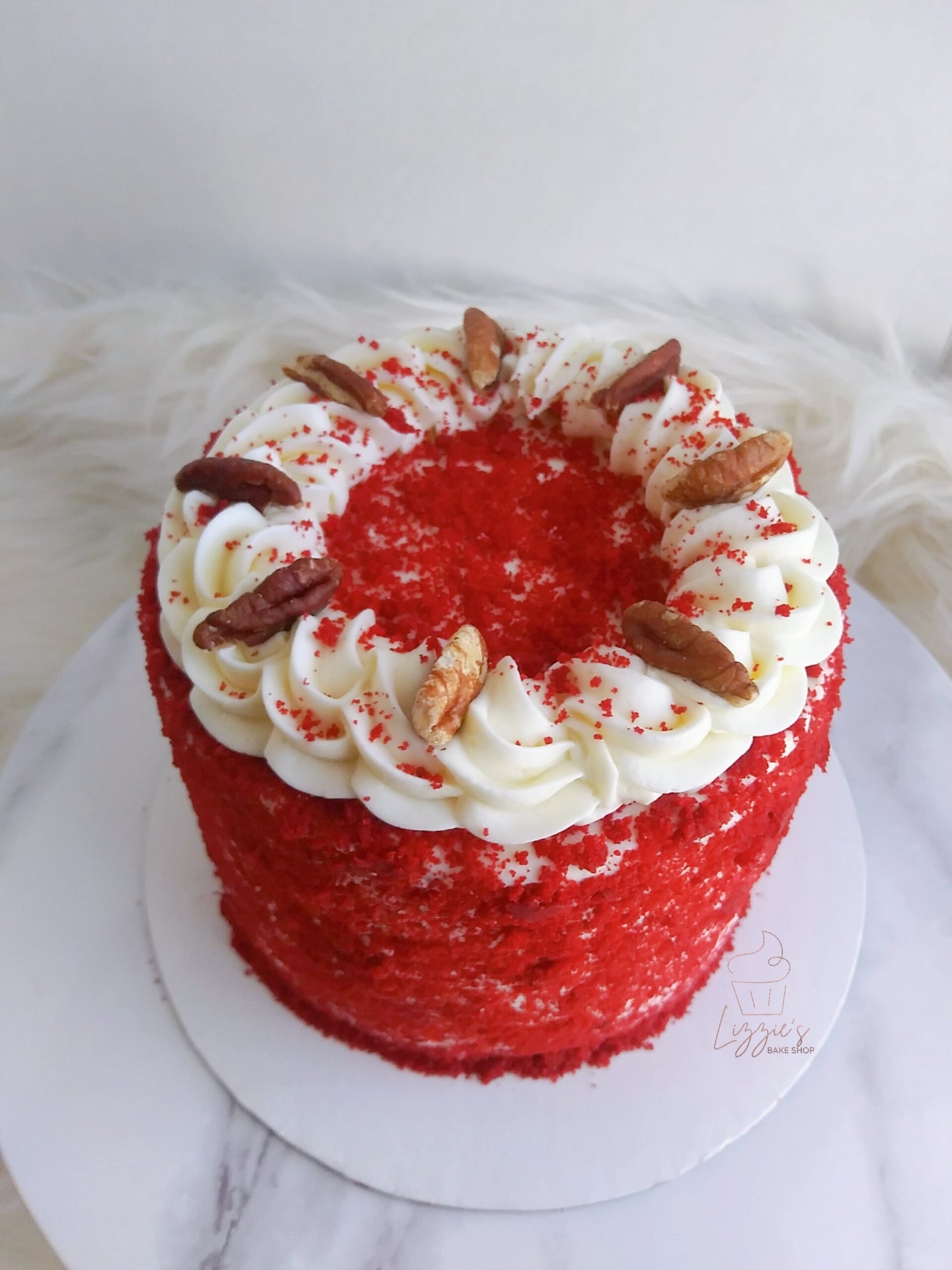 Red Velvet cake layered and frosted in a cream cheese buttercream icing (*Pecans are optional)